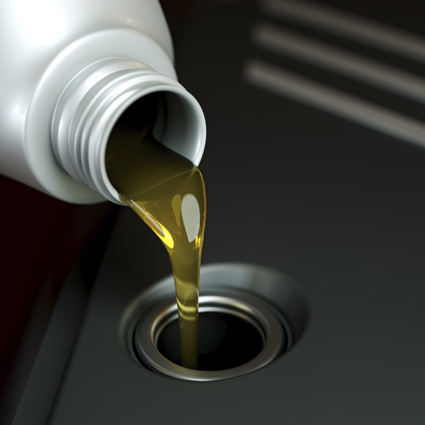 Up close image of motor oil being poured into a car