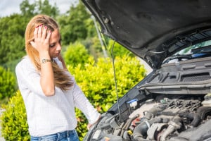 Image - Woman looking at engine, does not know what it is wrong.