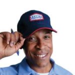 image of smiling AAMCO mechanic, tipping hat at you.