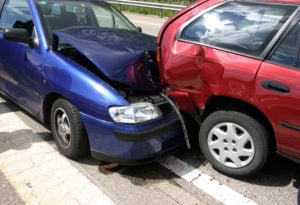 AAMCO Colorado Brake Repair Services - Don't Let Your Brakes Go Bad image of car wreck - two cars in a collision, one blue car crashed into rear end of red car.