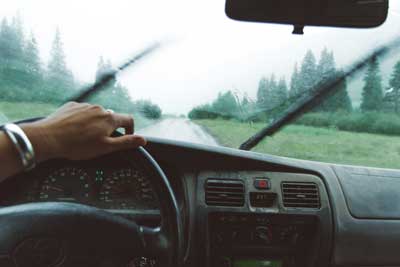Image of women driving during rainy hailstorm