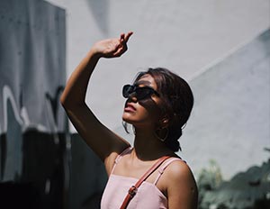 Image of women blocking sun wearing shades