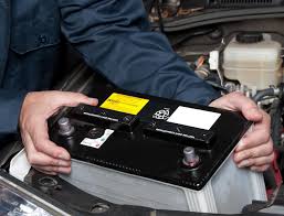 up close image of a mechanic replacing a car battery