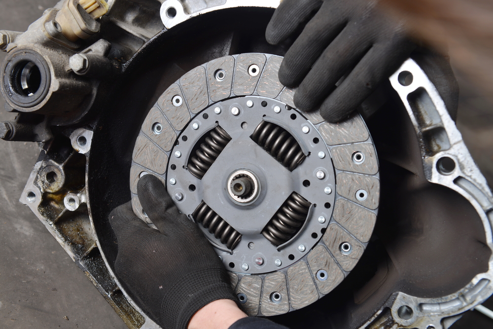 image of mechanic holding clutch disk in place